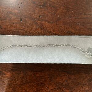 Large costume tennis bracelet. Measures about 8.25” it is new and never used.